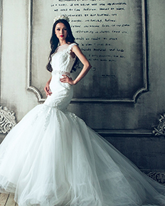 A bride in a fit and flare wedding dress